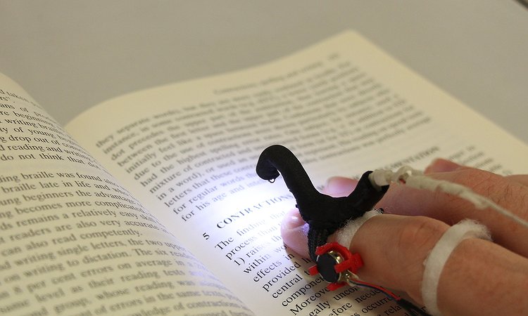 An early HandSight prototype for reading printed text