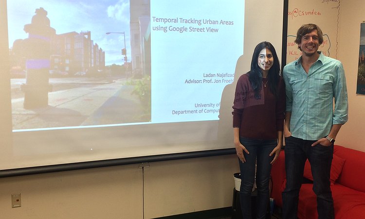 Ladan and Jon standing in front of Ladan's thesis proposal slides